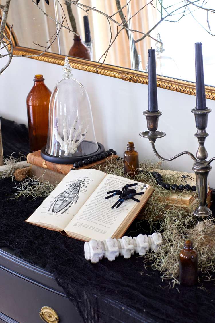 Spooky entry table: Use themed props at the entrance to guide guests into your haunted-house path.